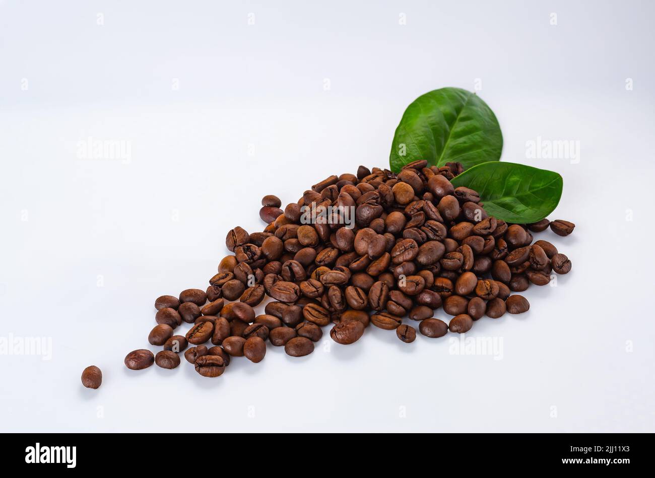 group of coffee beans with green leaves. coffee grains and leaves on a ...