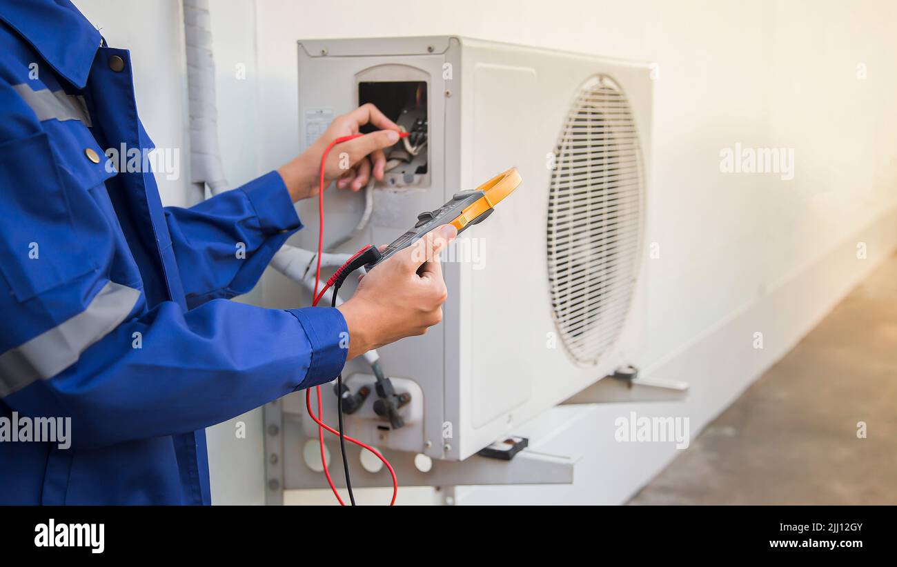Technician checking the operation of the air conditioner Stock Photo ...