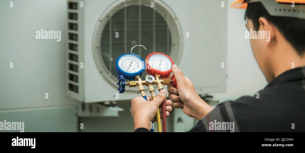 Technician checking the operation of the air conditioner Stock Photo ...