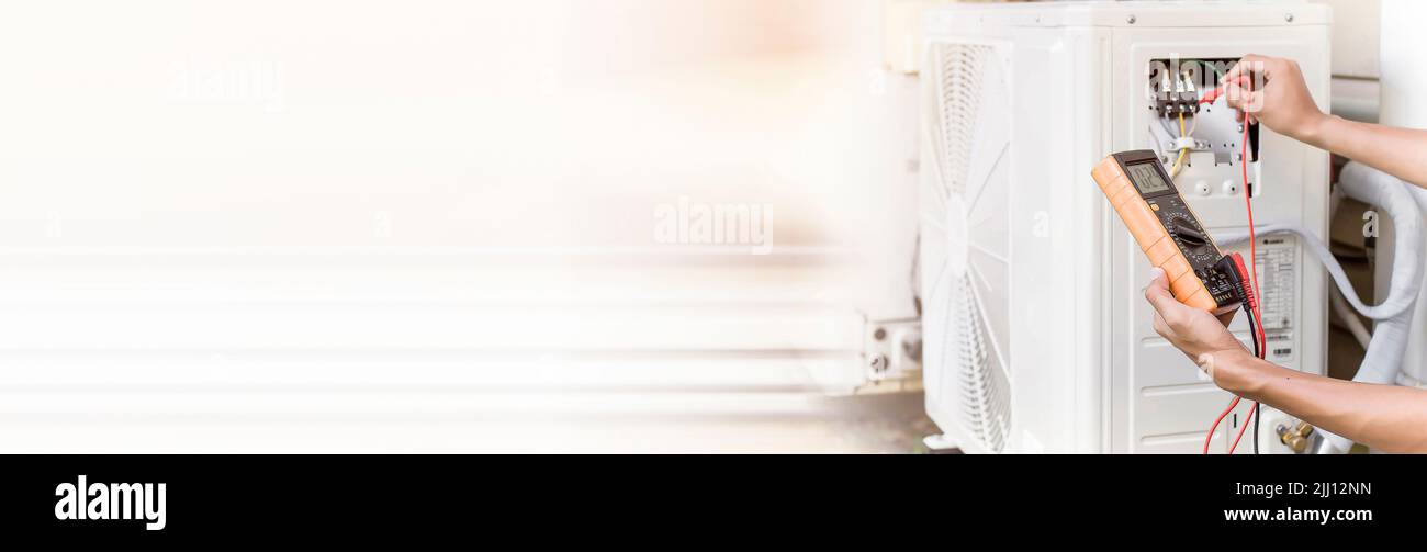 Air conditioner repairman using electricity meter to check air