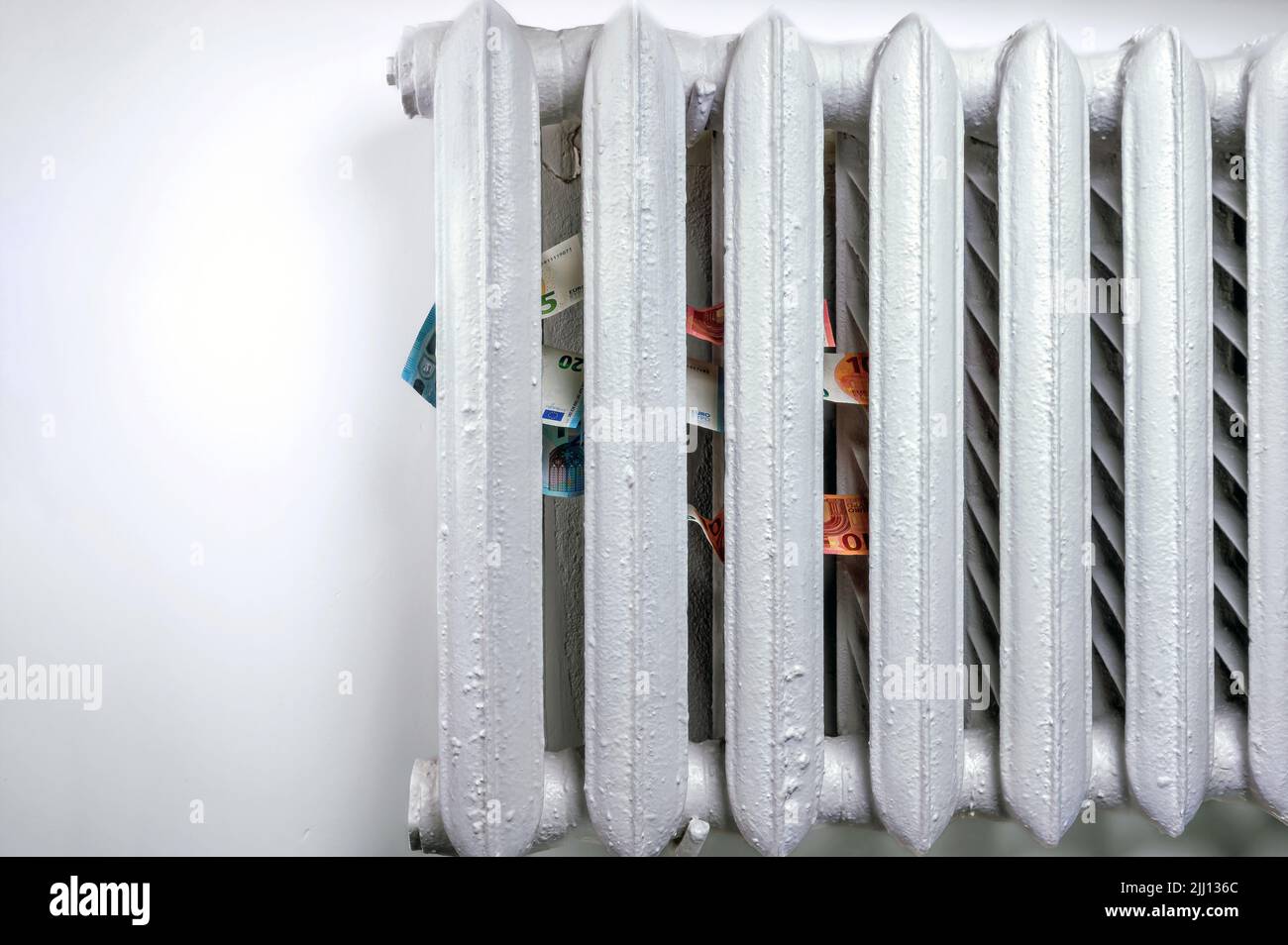 euro banknotes in a central heating radiator, the concept of expensive