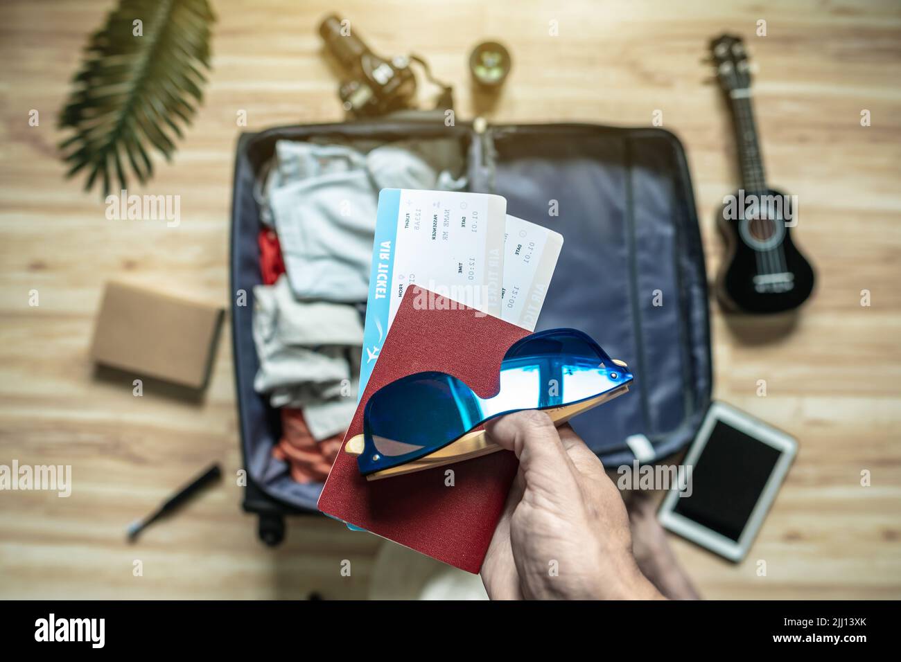 Packing a suitcase for a summer vacation. Preparation of things and documents for a longawaited