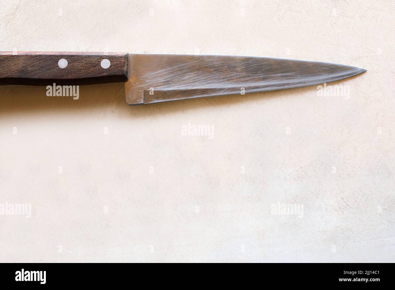 Cutting wooden desk with knife Stock Photo - Alamy