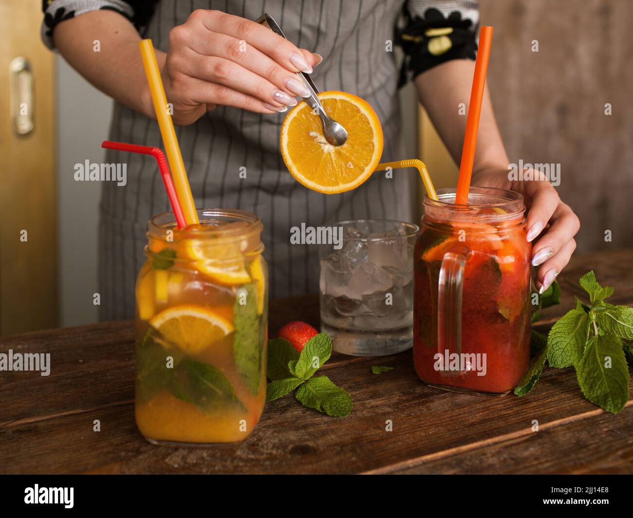 Waiter preparing fruit cocktails in restaurant Stock Photo
