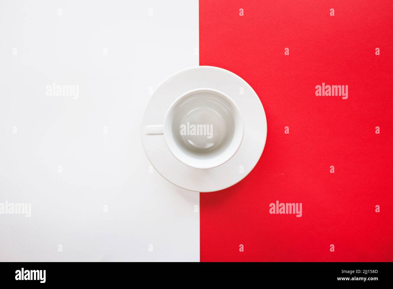 Empty tea cup isolated on red and white background Stock Photo