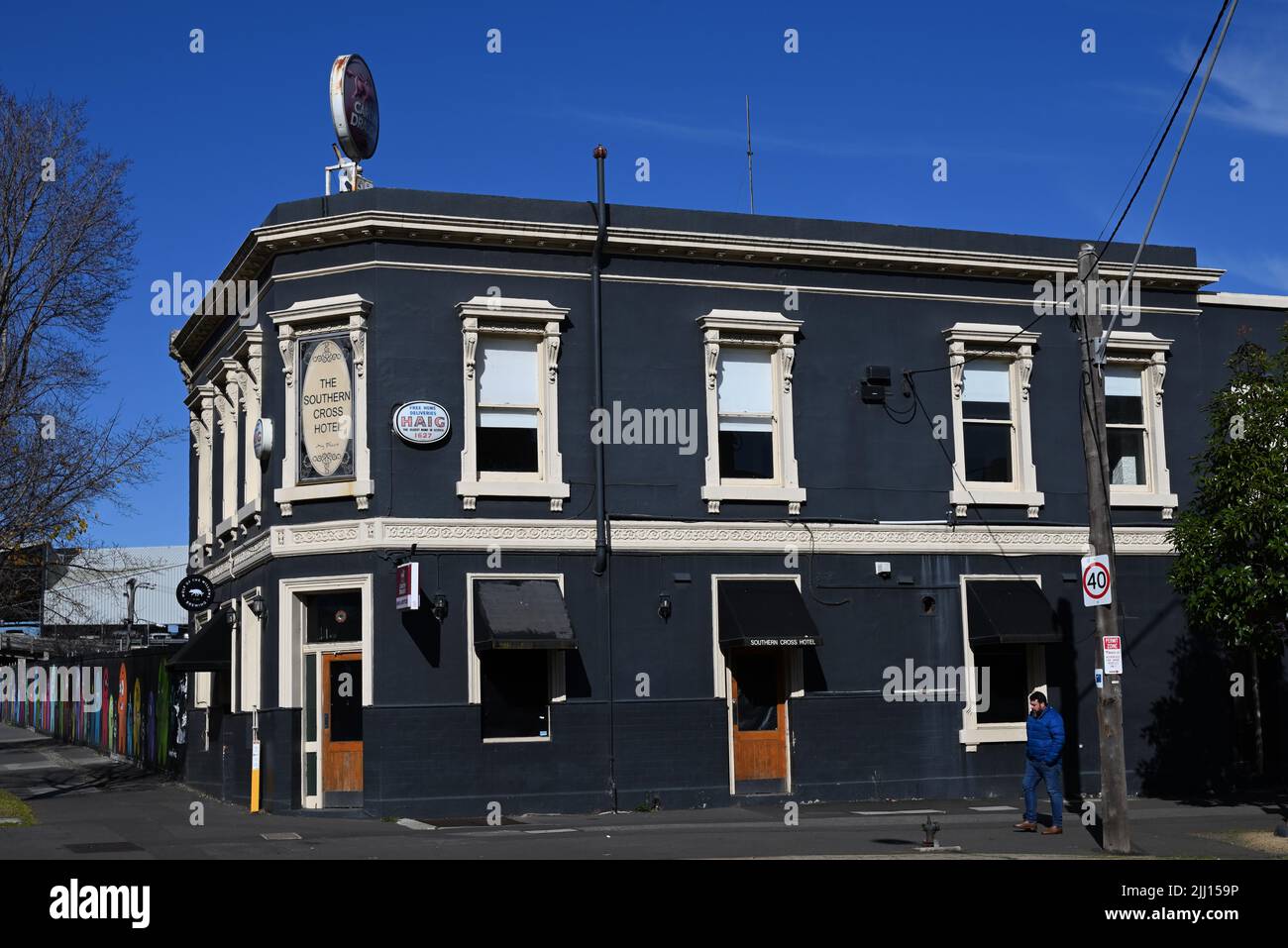 The Southern Cross Hotel, on the corner Cecil St and Market St, seen on a sunny day as a lone man walks by Stock Photo