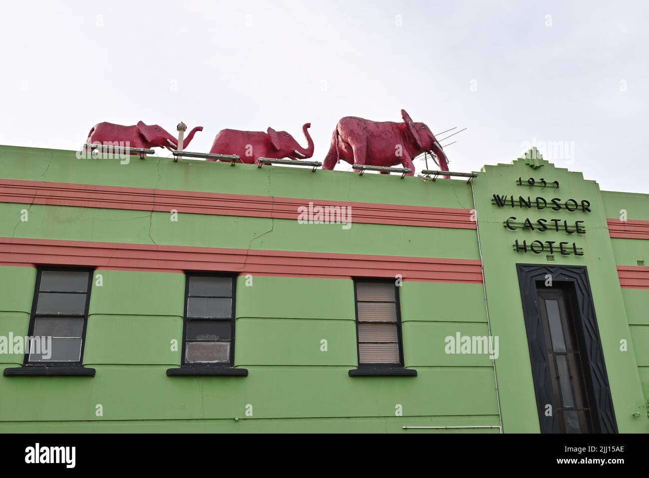 Three pink elephant sculptures atop the colourful Windsor Castle Hotel, a pub in Melbourne's inner suburbs Stock Photo
