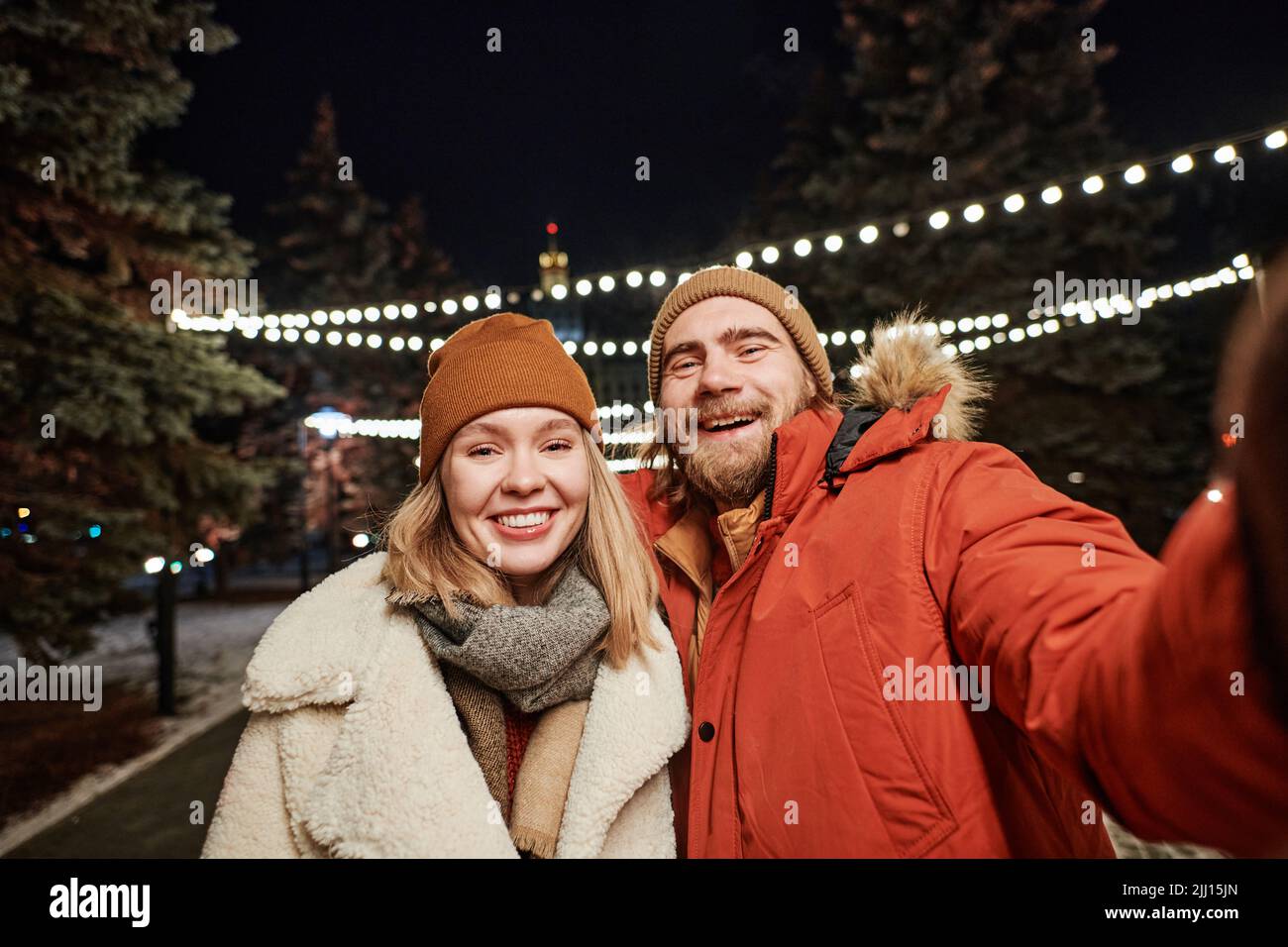 Horizontal medium shot joyful young couple spending winter evening