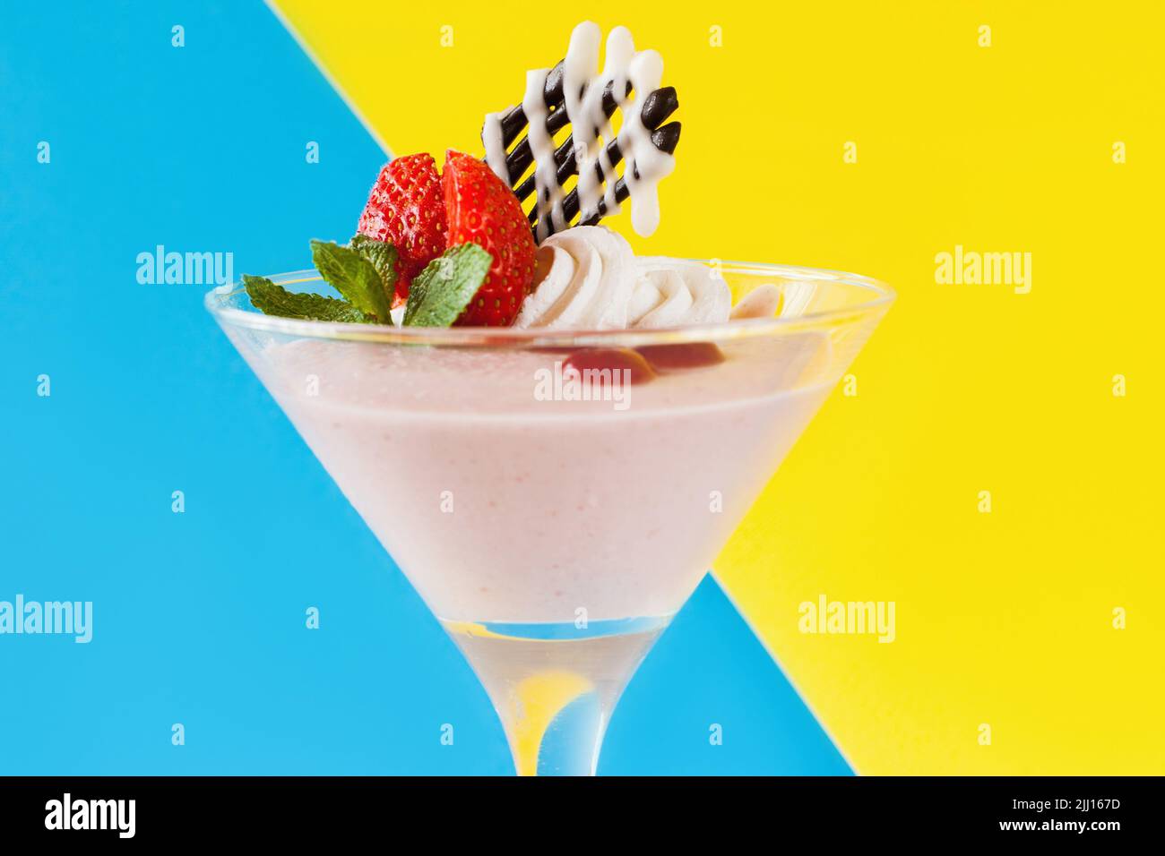 Creamy strawberry dessert on contrast background Stock Photo