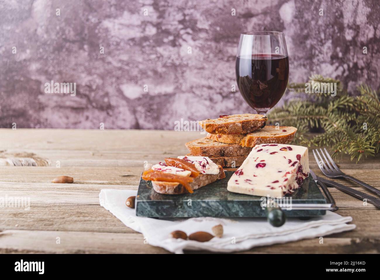 A closeup shot of Wensleydale cheese with cranberries and wine. Stock Photo