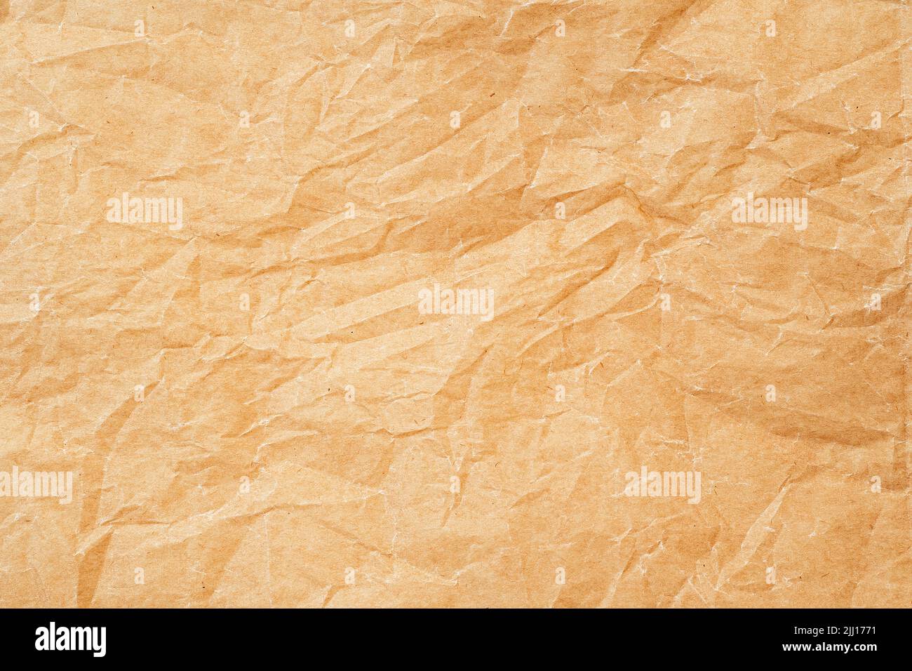 Crumpled thin parchment paper as texture or background, baking parchment Stock Photo