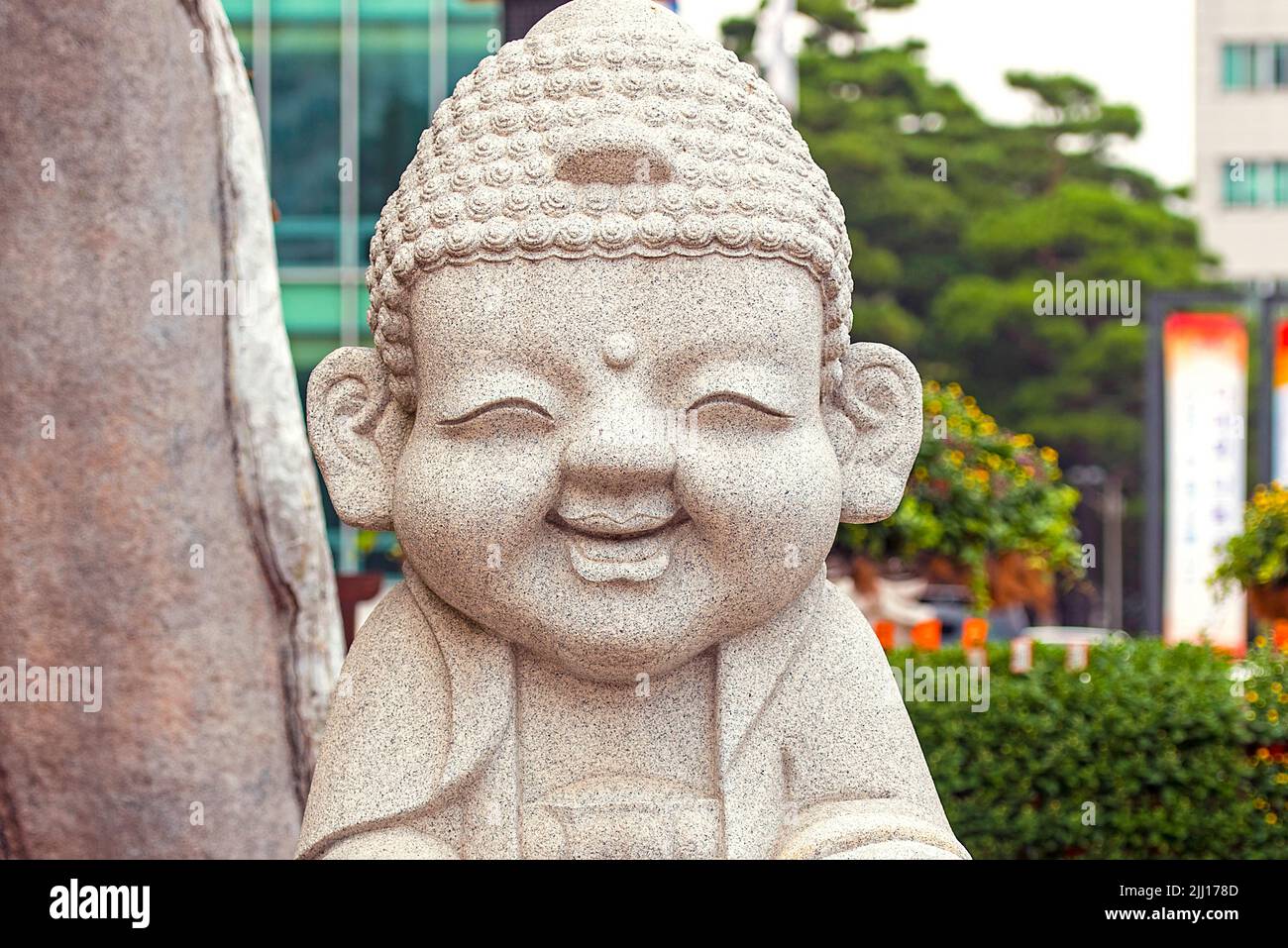 Smiling stone buddha statue at the Jogyesa temple in Seoul Stock Photo