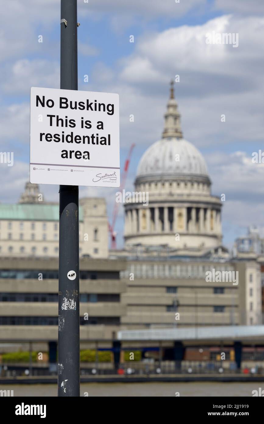 London, England, UK. No busking sign on the South Bank, St Paul's Cathedral in the background Stock Photo