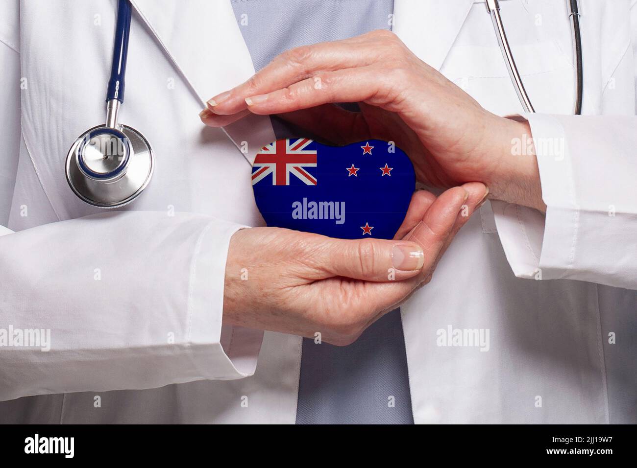 New Zealand doctor holding heart with flag of New Zealand background
