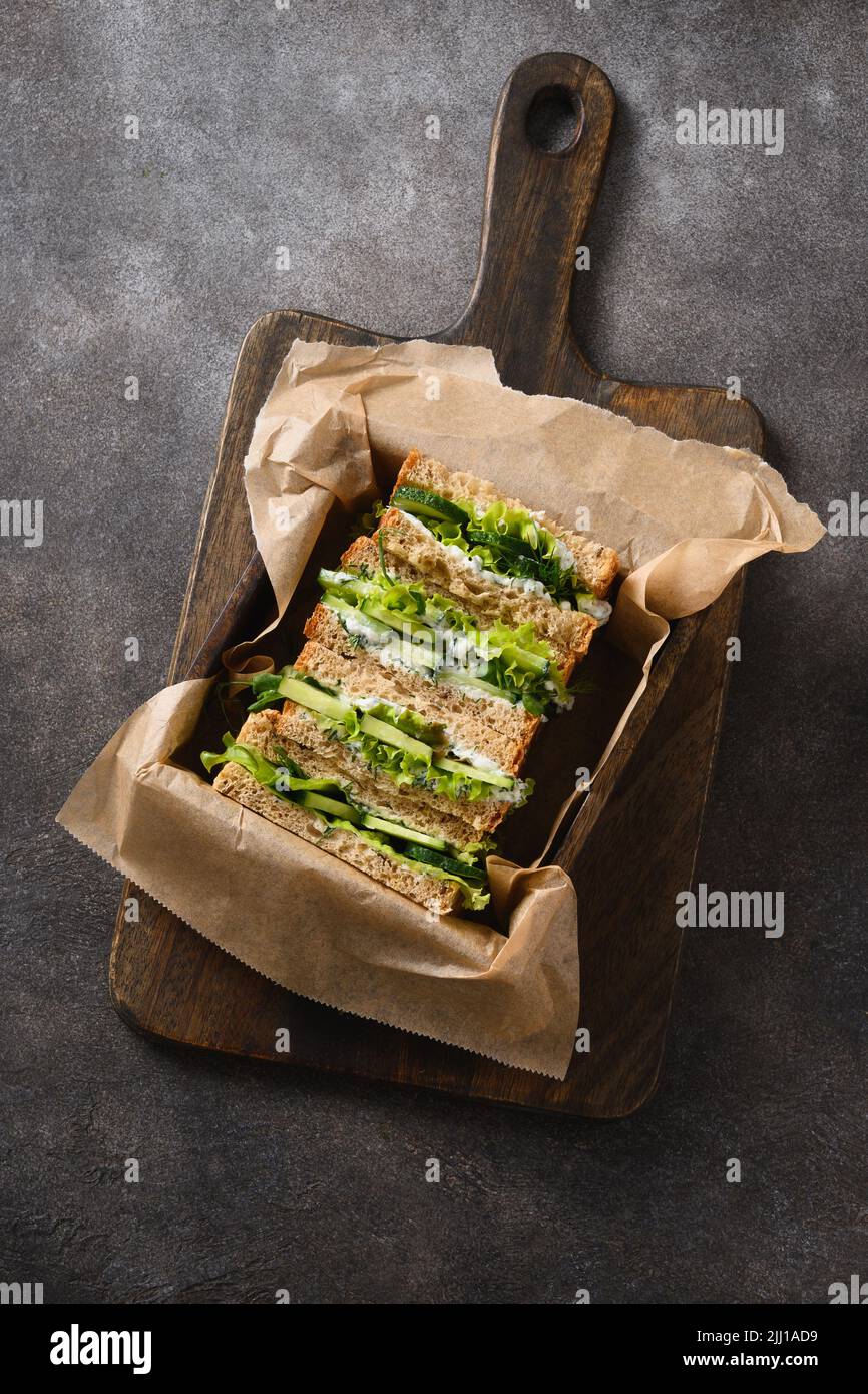English tea sandwiches with cream cheese, dill, cucumber on brown