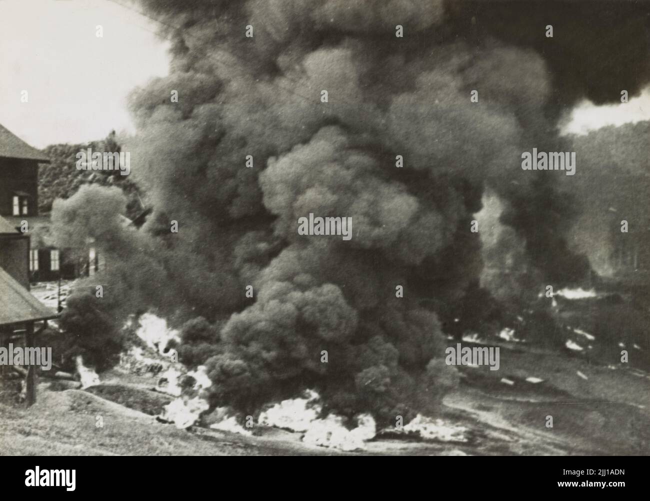 A vintage photo circa February 1942 showing a rubber factory being burned by retreating British forces in Malaya during the Japanese invasion of 1942. The British employed a scorched earth policy to prevent valuable resources such as rubber from falling in to Japanese hands Stock Photo