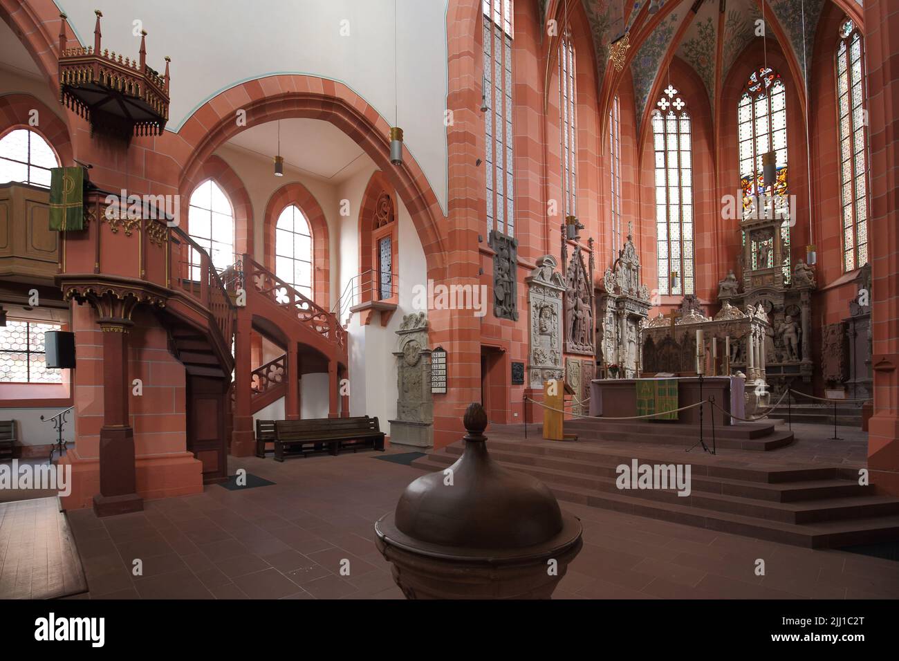 Altar room with pulpit and baptismal font of the late Gothic collegiate church in Wertheim, Baden-Württemberg, Germany Stock Photo