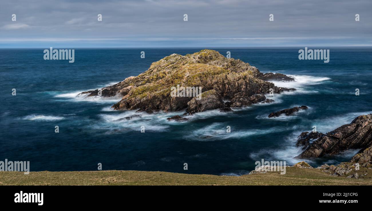 The small island of Garbh-eilean near Strathy Point on the north coast of Scotland Stock Photo