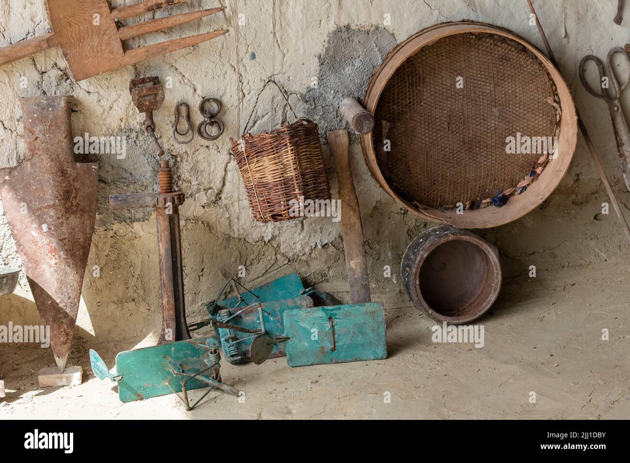 Selective focus shot of mini museum with old-style traps and wooden baskets, sieves and tools used in the village. Stock Photo