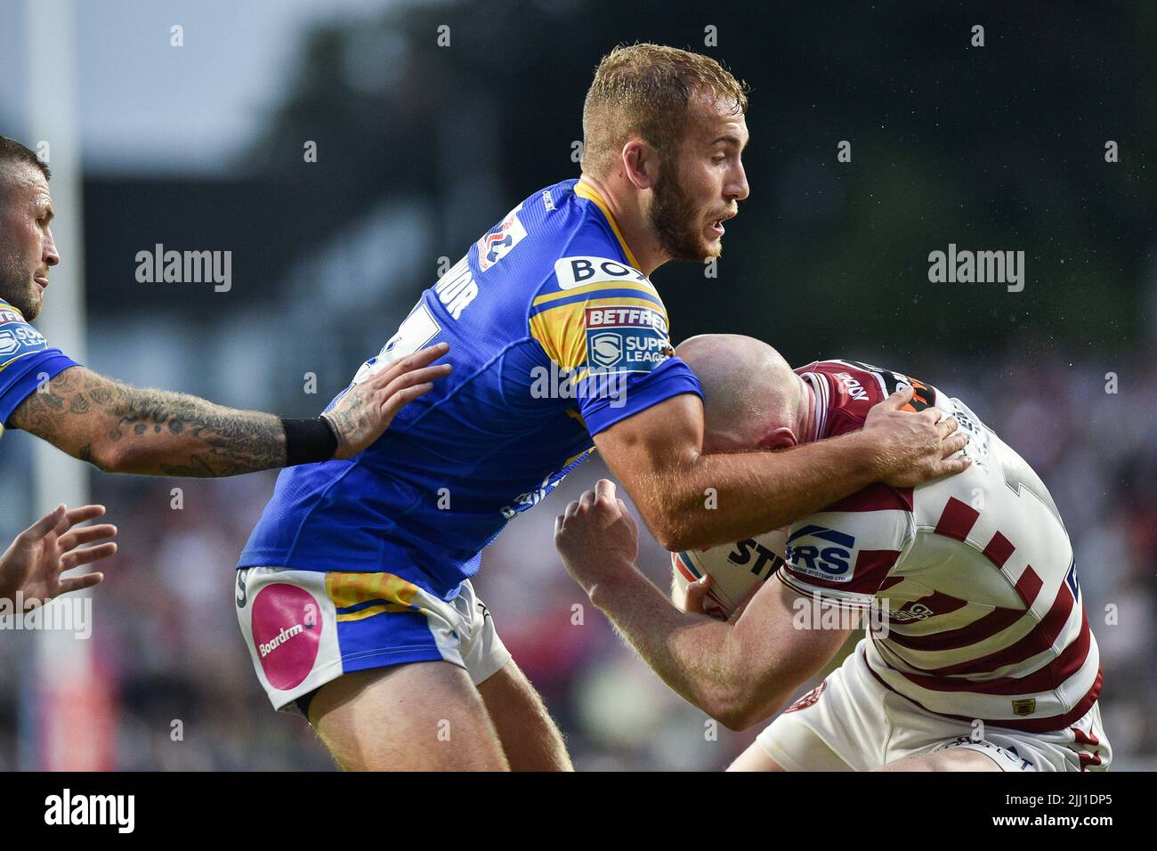 Leeds, England - 21st July 2022 -  Jarrod O'Connor (24) of Leeds Rhinos tackles Liam Farrell of Wigan Warriors. Rugby League Betfred Super League Leeds Rhinos vs Wigan Warriors at Headingley Stadium, Leeds, UK Stock Photo