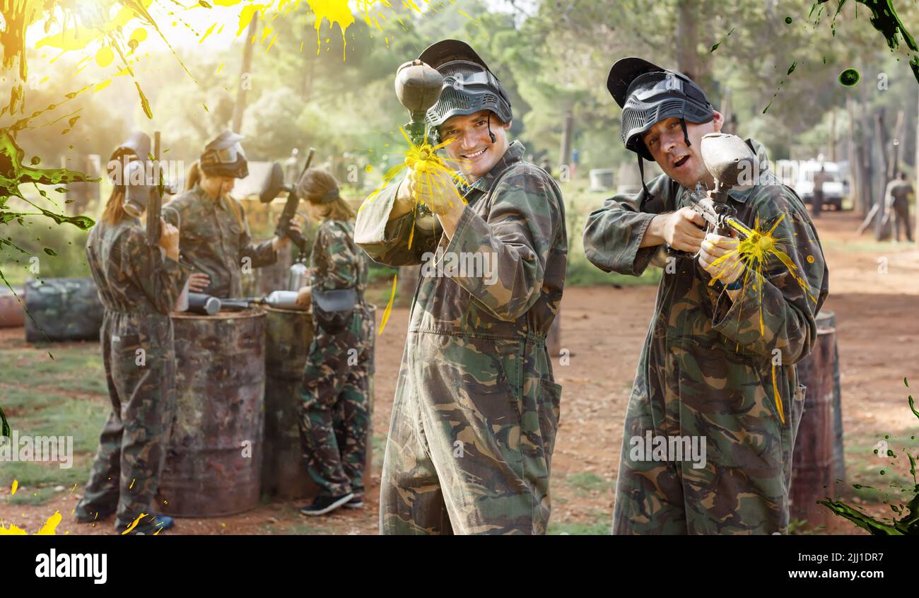 Two cheerful paintball players in full gear having fun outdoors Stock Photo Alamy