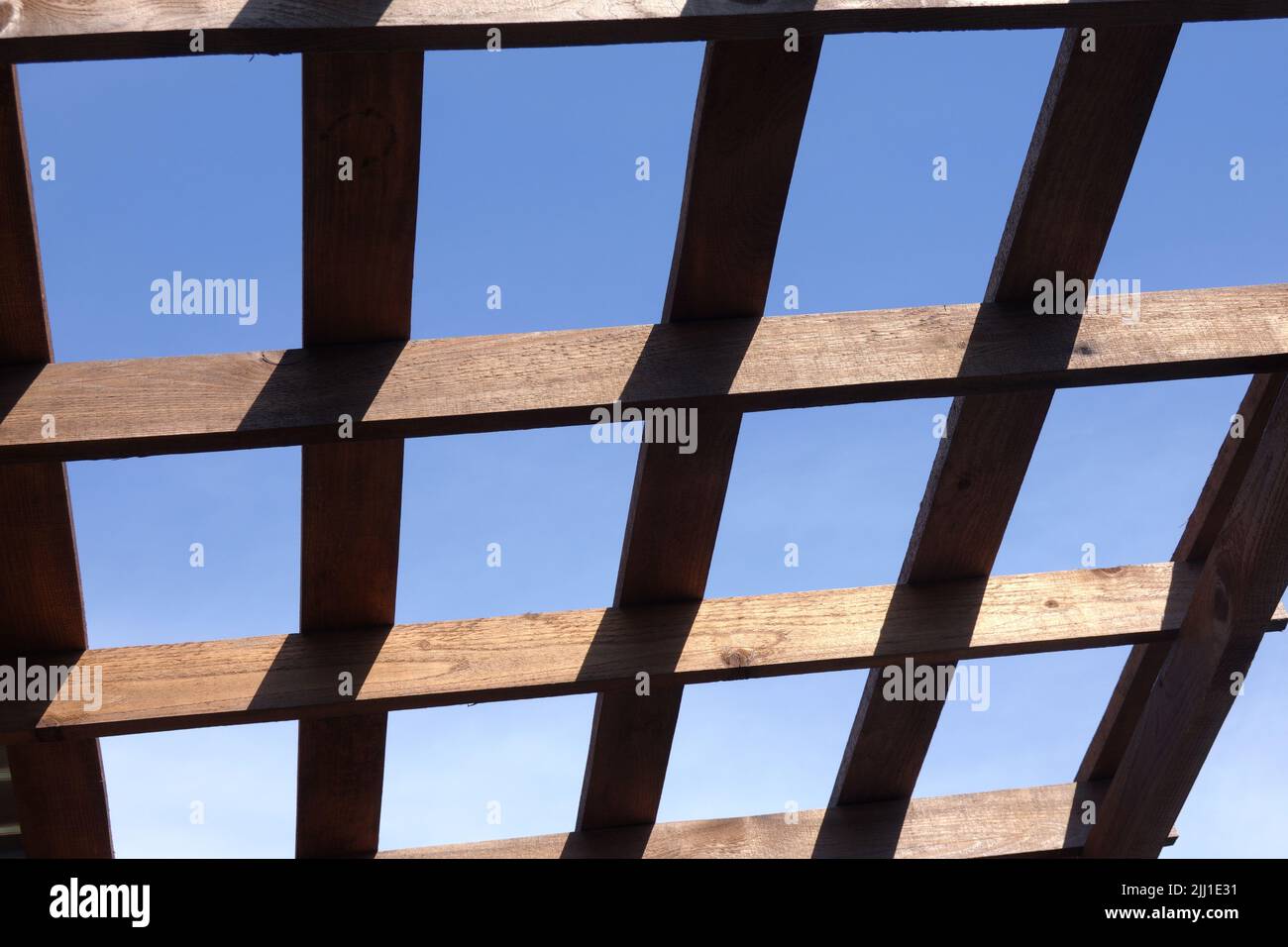 Top of a brown wooden gazebo on a sunny summer day bottom up view outdoors Stock Photo