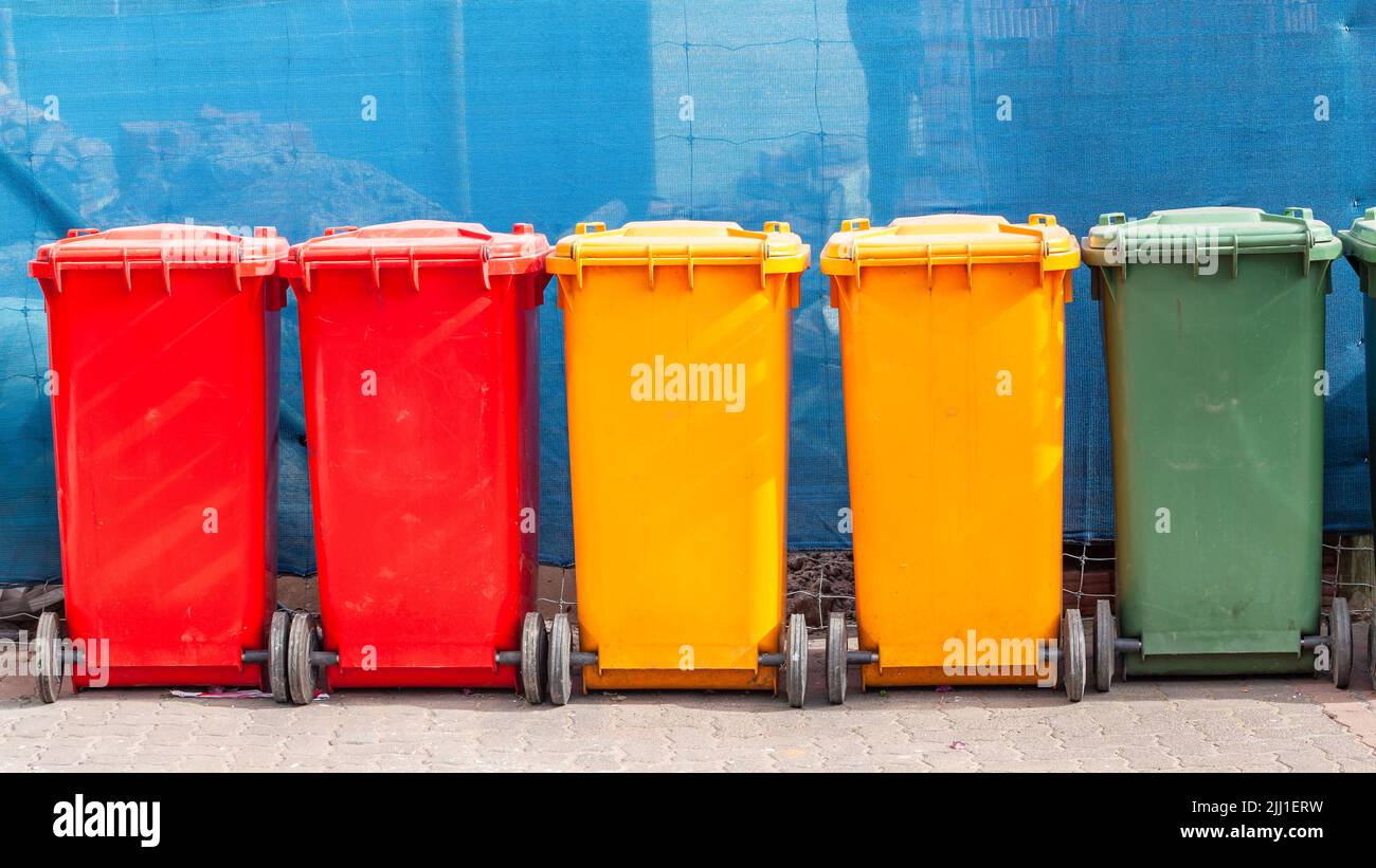 Rubbish litter nins stacked together for van collection of trash to