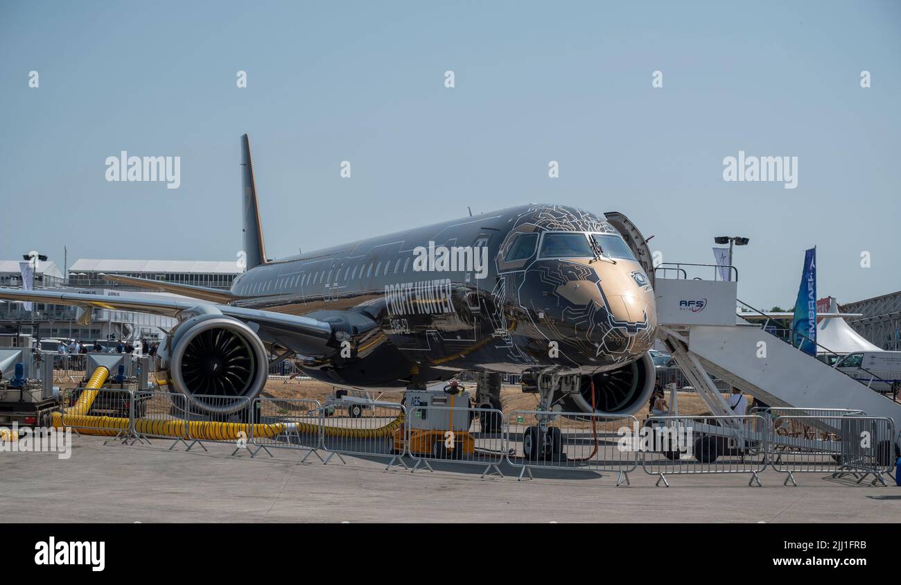 Farnborough International Airshow, 18 July 2022, Hampshire, England, UK. Embraer E195-E2 regional passenger jet with gold and black livery in the static display at the Trade Airshow. Stock Photo