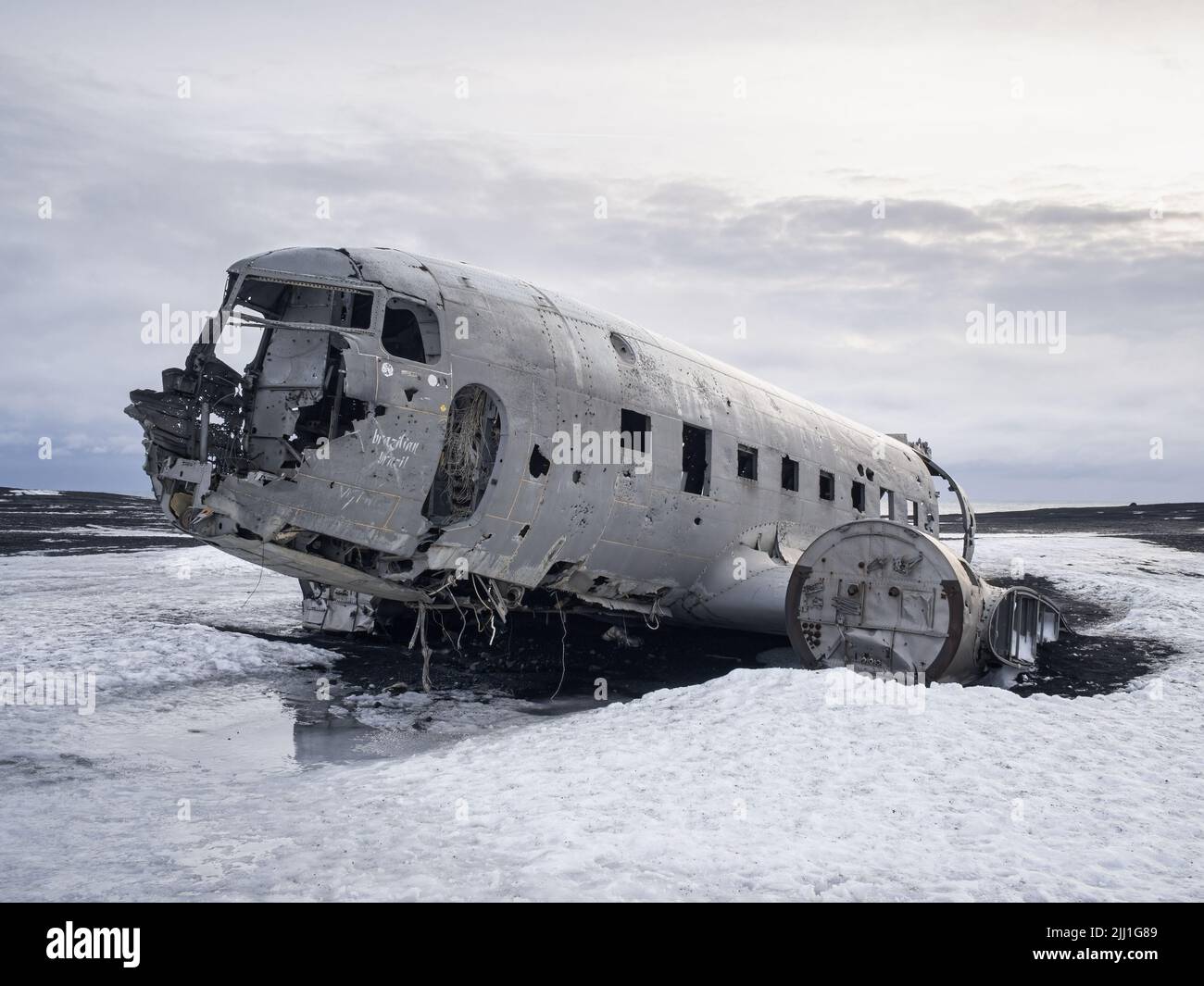 A wrecked and abandoned Douglas DC-3 airliner on the beach at Sólheimasandur, Iceland. Stock Photo