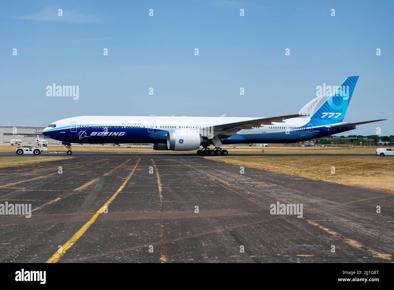 Boeing 777-9, also known as 777X, airliner jet plane at Farnborough International Airshow 2022. Being towed out to display. Side view Stock Photo