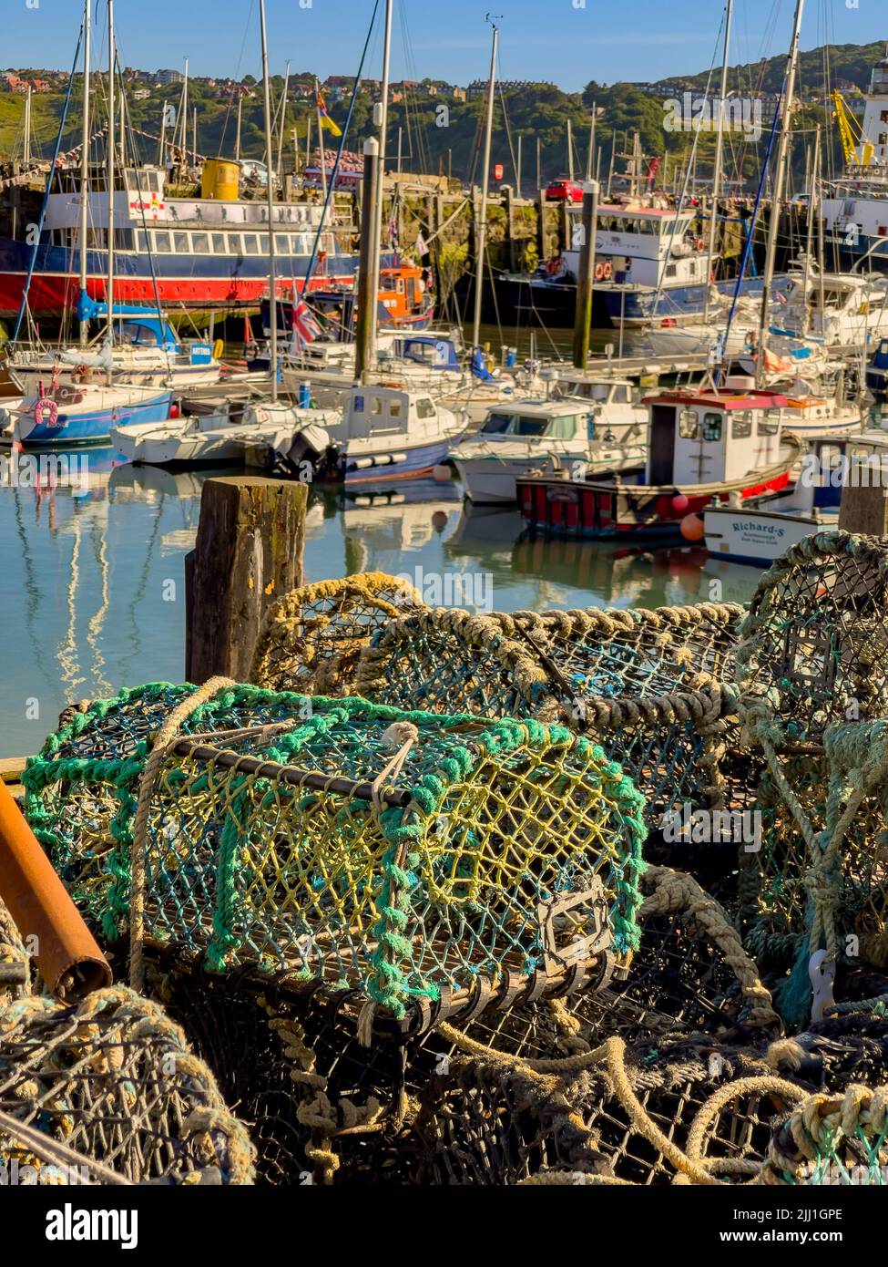 Lobster pots and boats in South Bay Harbour, Scarborough, UK Stock Photo