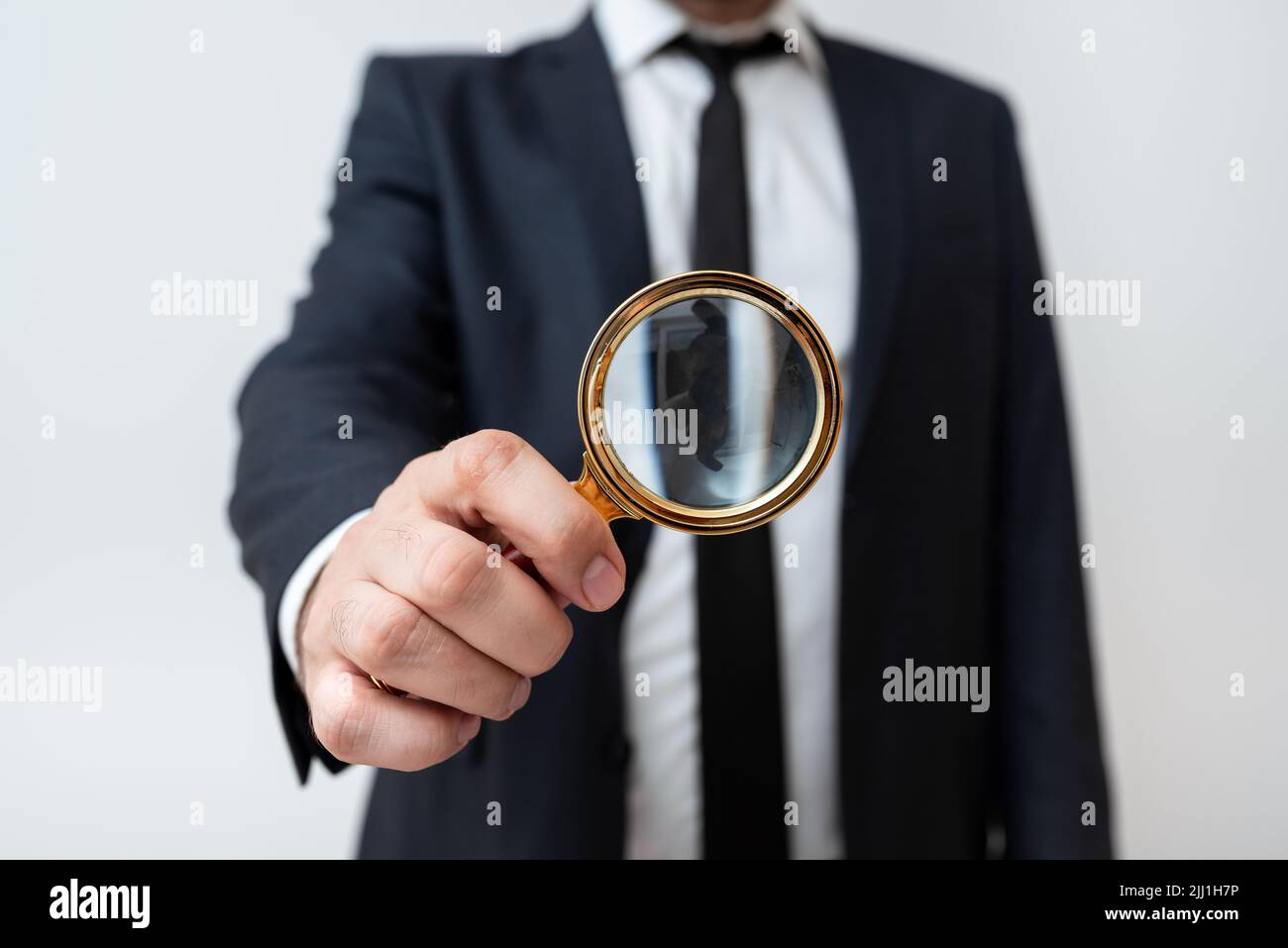 Businessman Holding Magnifier In One Hand. Man Having Magnifying Glass To Point Important