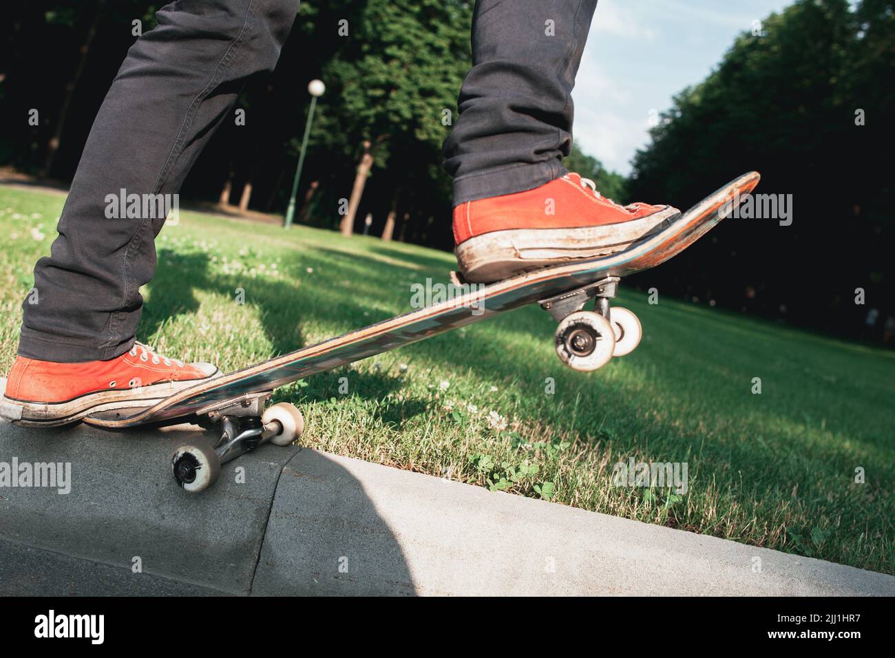 Skateboarder make back slide trick on park Stock Photo Alamy