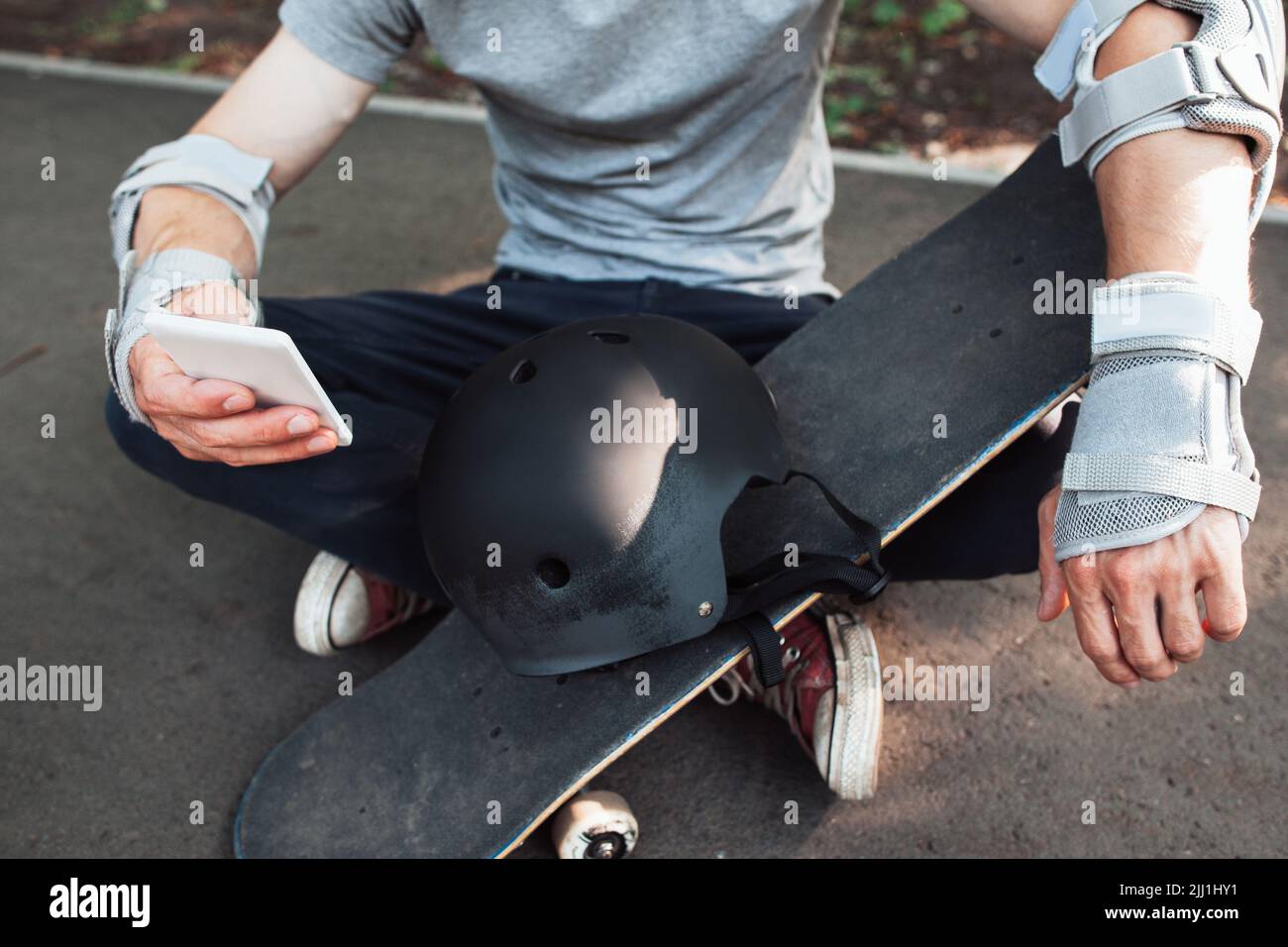 Professional skateboarder checking online network Stock Photo
