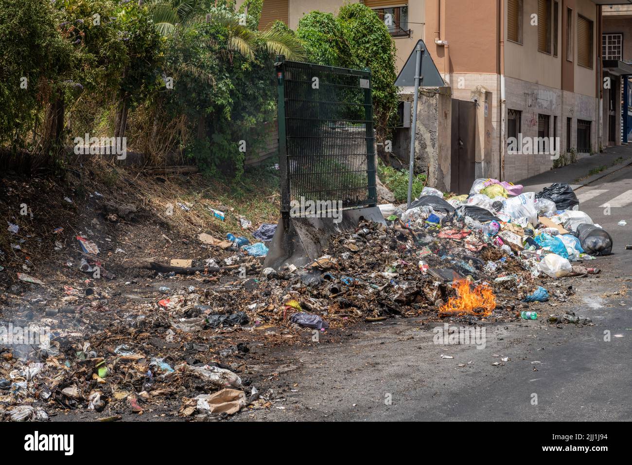 Domestic refuse burning on the street in Catania, Sicily, Italy. Proper waste disposal is a huge problem in the city and across much of Sicily Stock Photo