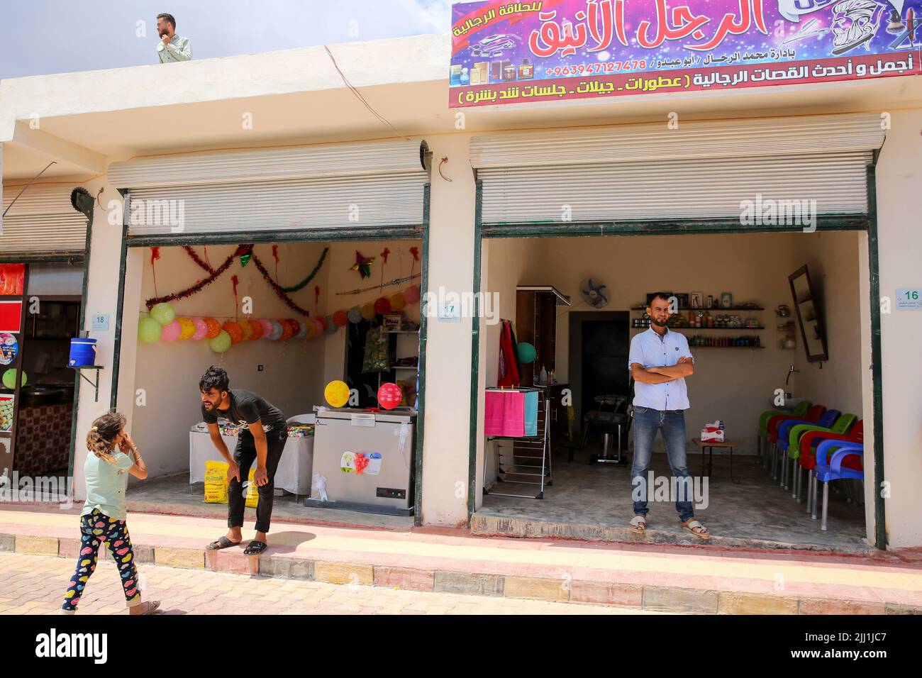 Marshad Ruhin, Idlib, Syria. 21st June, 2022. Idlib, Syria. 21 June 2022. The official opening of a bazaar with various shops near displacement camps in the Marshad Ruhin area of Idlib. The market is part of a project set up by the Takaful Al-Sham and Muslim Aid NGOs to provide 60 displaced and vulnerable Syrian families in northwest Syria with a shop to give them the chance to run a business and earn a livelihood (Credit Image: © Juma Muhammed/IMAGESLIVE via ZUMA Press Wire) Stock Photo