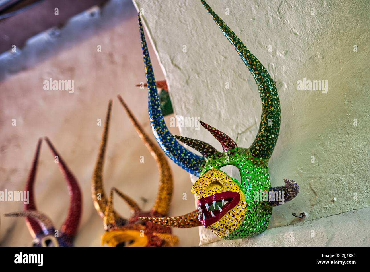 A closeup shot of colorful 'vejigante' folkloric character's mask hanging on the wall Stock Photo