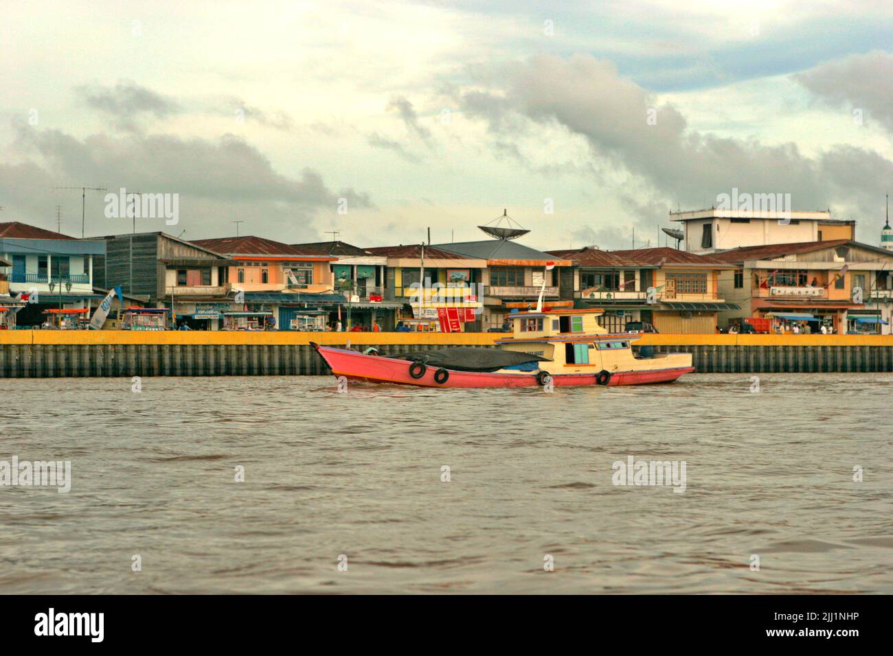A line of commercial buildings are seen from Segah river in Tanjung Redeb, Berau, East Kalimantan, Indonesia. Stock Photo