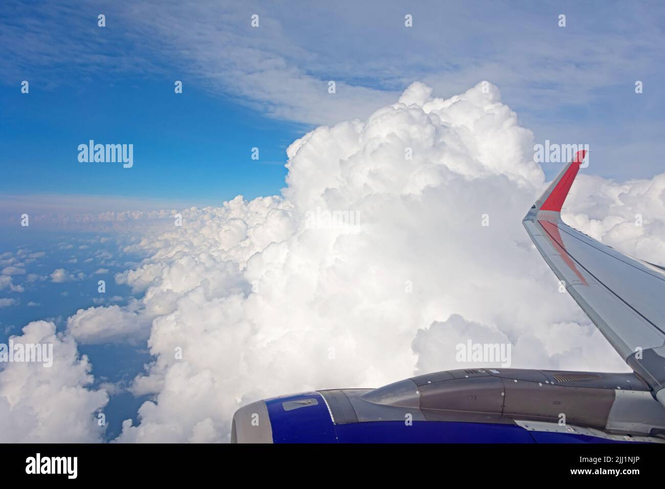 Flying over arrays of cumulus clouds on a summer day. Travel ticket for vacation Stock Photo