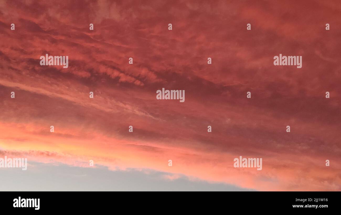 Abstract dark red background. Dramatic red sky. Red sunset with clouds