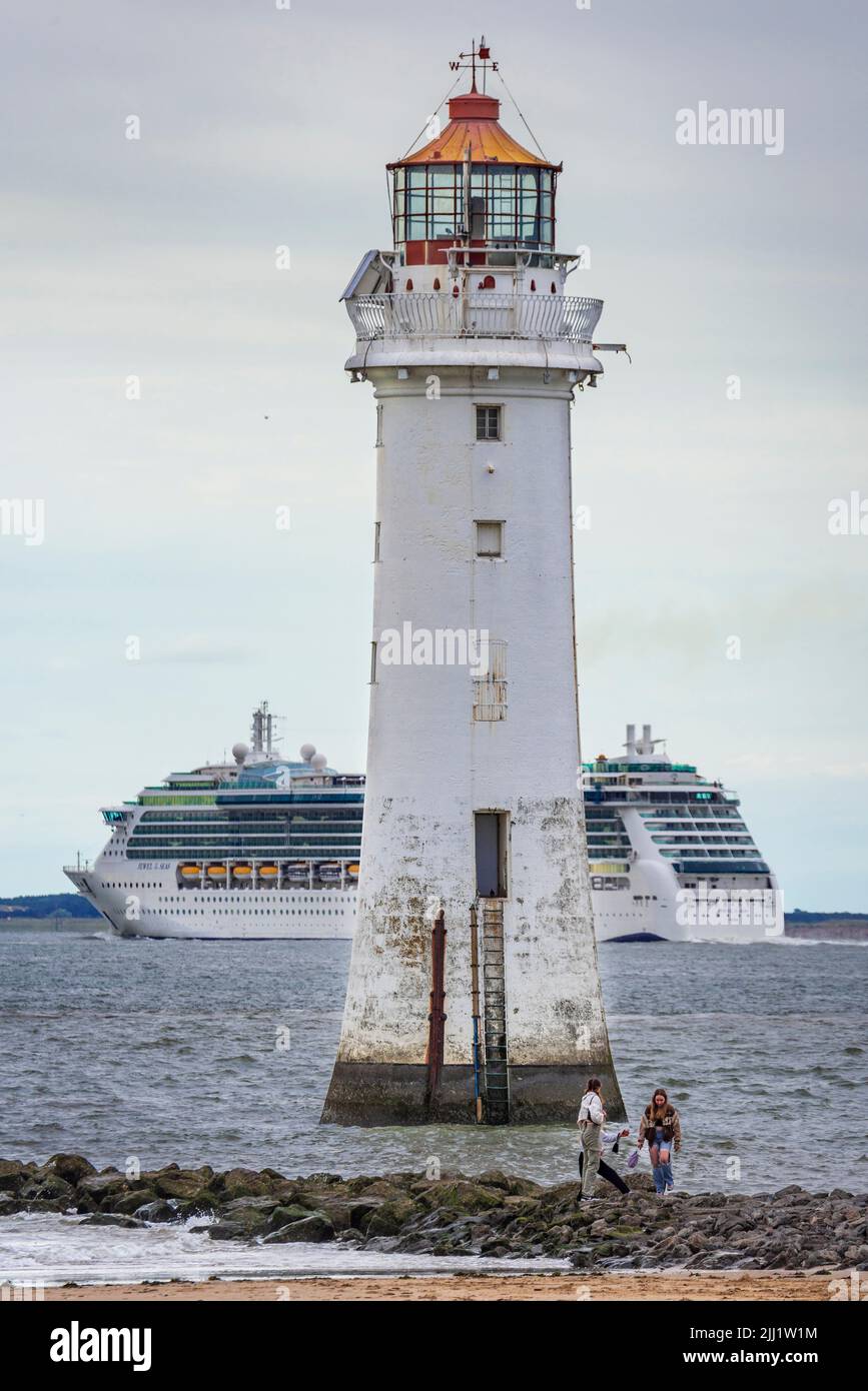 Jewel of the Seas ithe Radiance-class cruise ship operated by Royal Caribbean seen passing Perch Rock lighthoouse on the river Mersey. Stock Photo