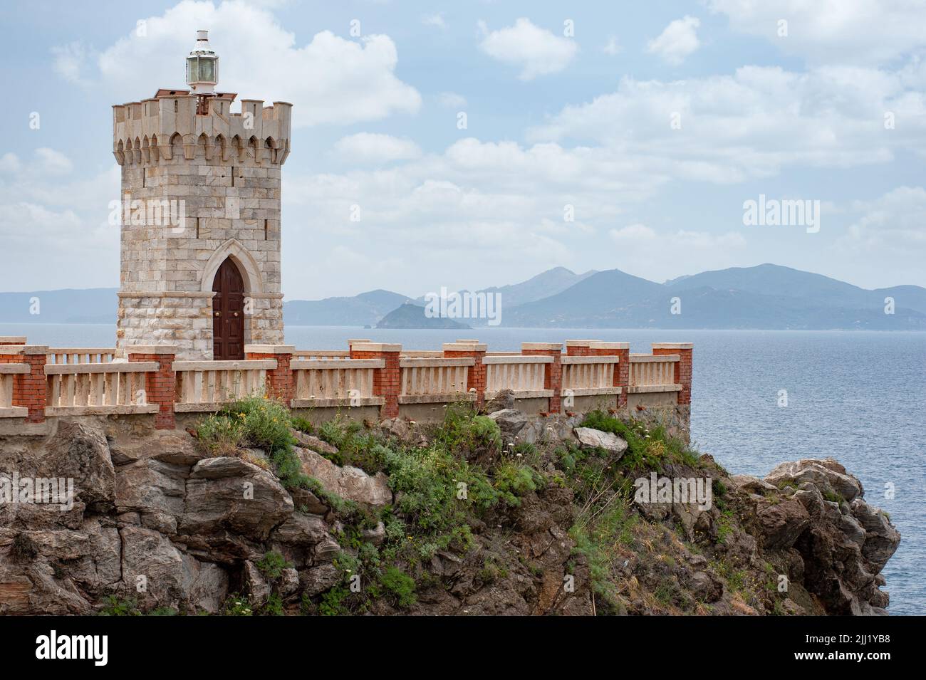 Piombino lighthouse (also known as Rocchetta lighthouse), it’s located on the natural terrace of Piazza Giovanni Bovio. Elba island in the background Stock Photo