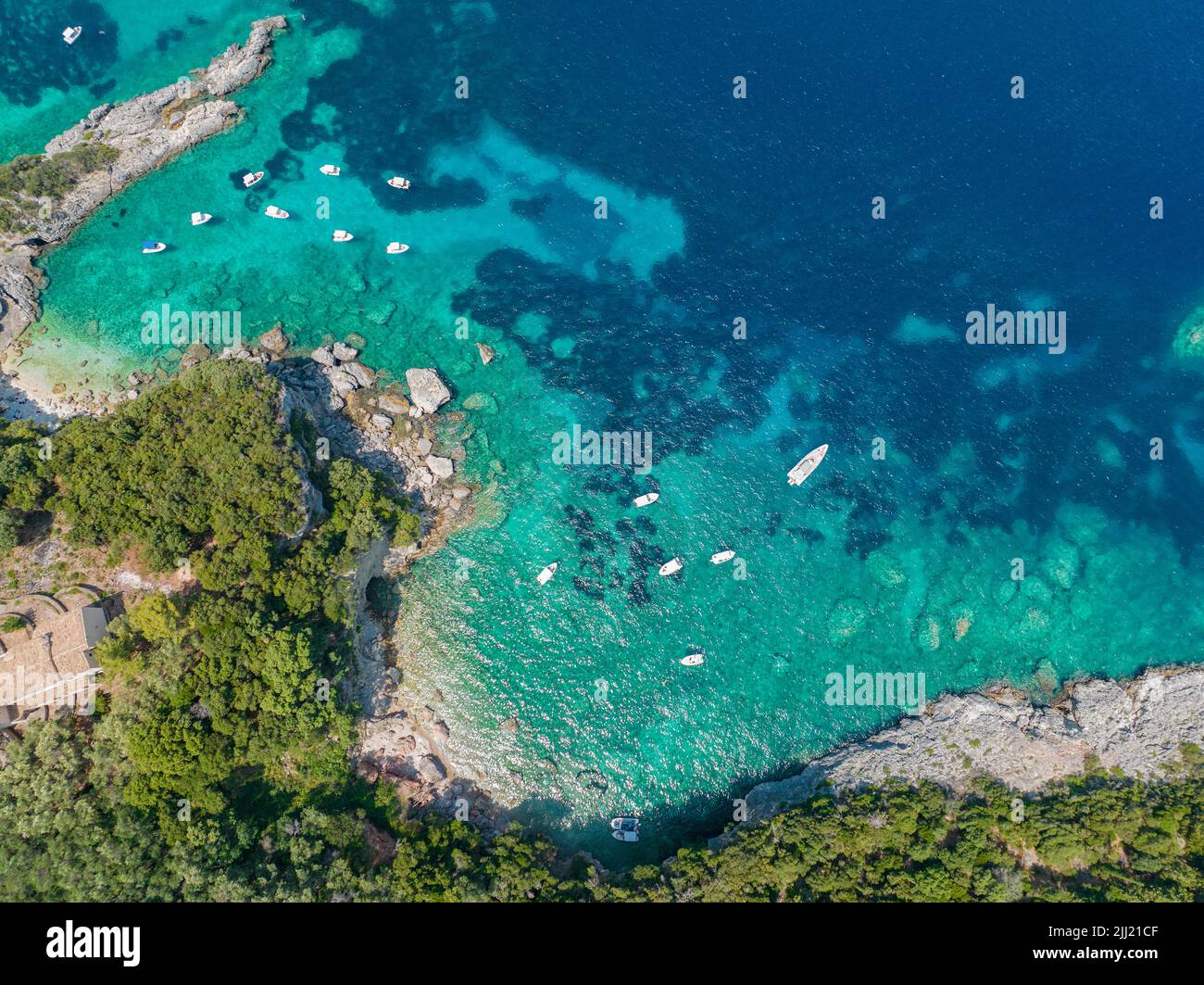 Aerial view of Klimatia Beach, close to Limni beach on the island of Corfu. Coastline. Transparent and crystalline water, moored boats. Greece Stock Photo