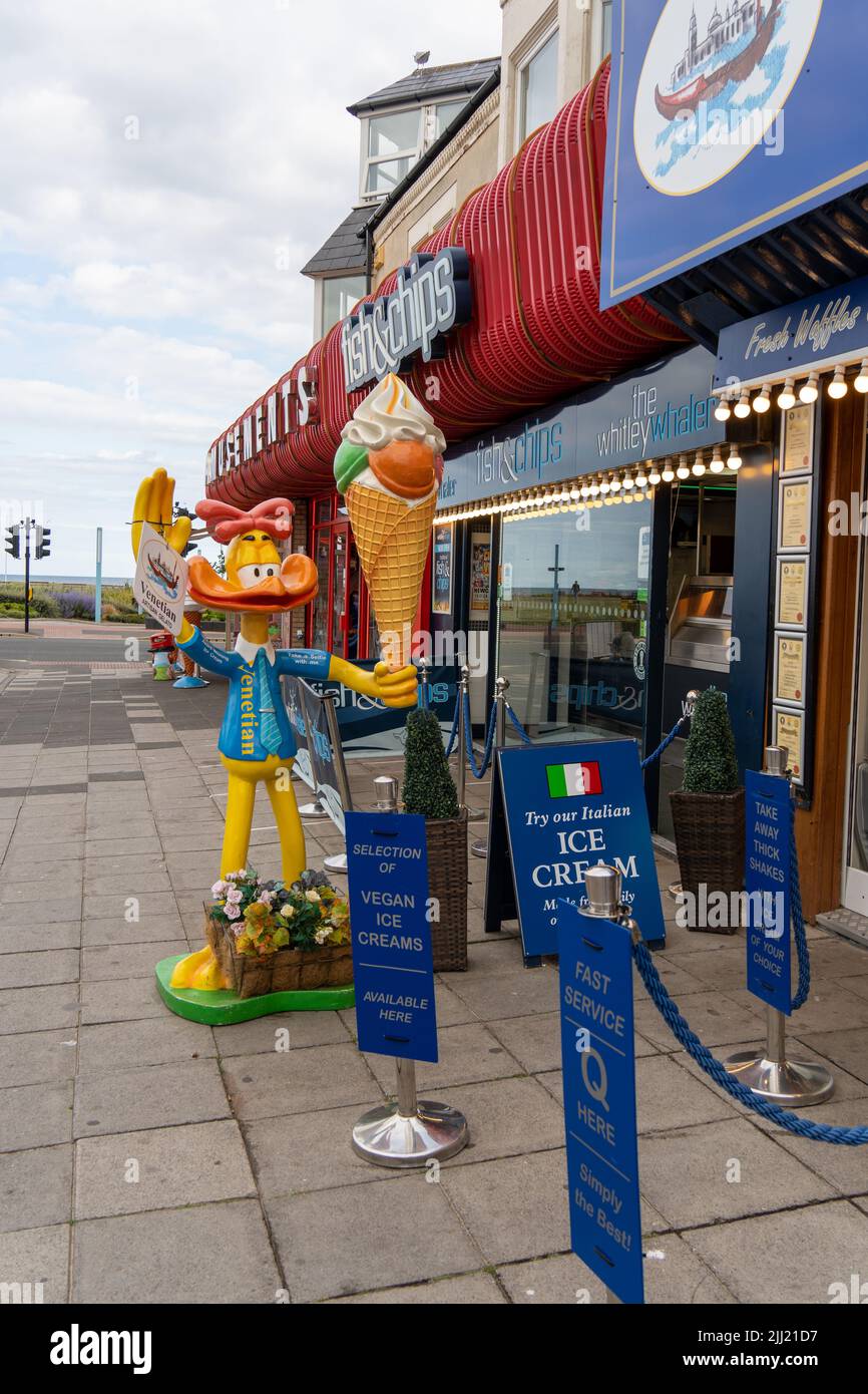 A cartoon character statue of a duck holding an ice cream, as advertising outside of a cafe near the sea front in Whitley Bay, North Tyneside, UK. Stock Photo