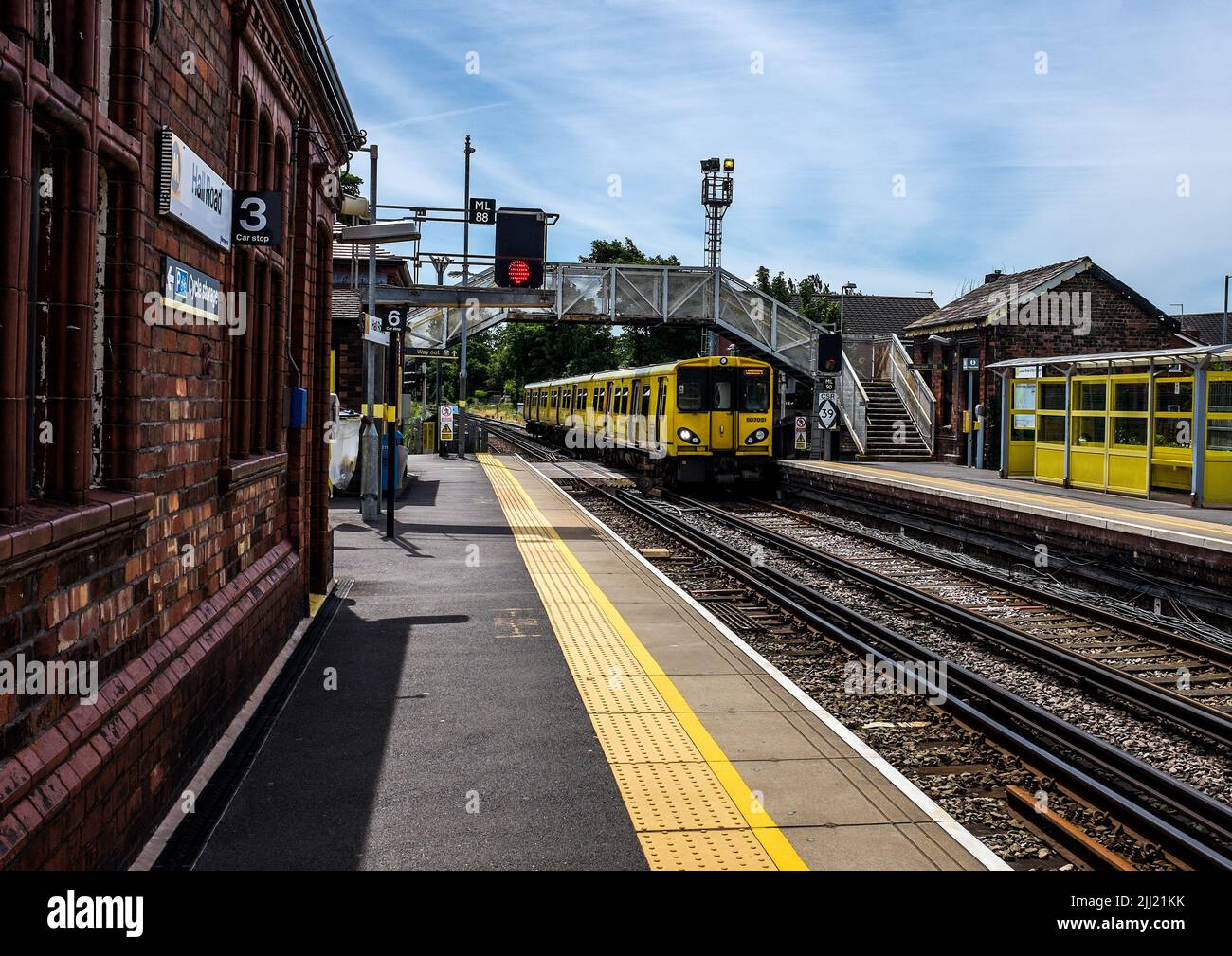 A Merseyrail train arrives at Hall Road station near Liverpool, England