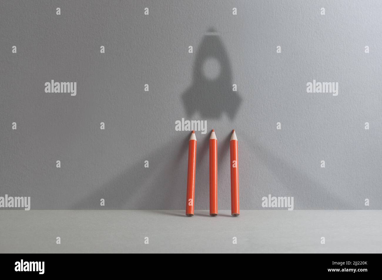 Back to school, success; realising dreams concept, rocket shadow with pencils Stock Photo