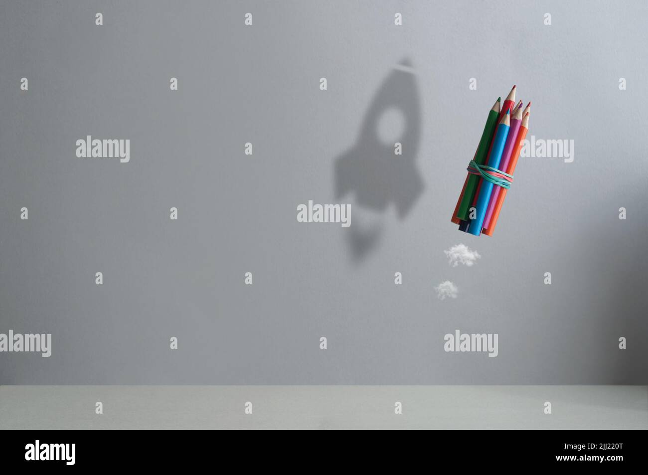 Pencil in air with shadow of a rocket, back to school, success; realising dreams concept Stock Photo