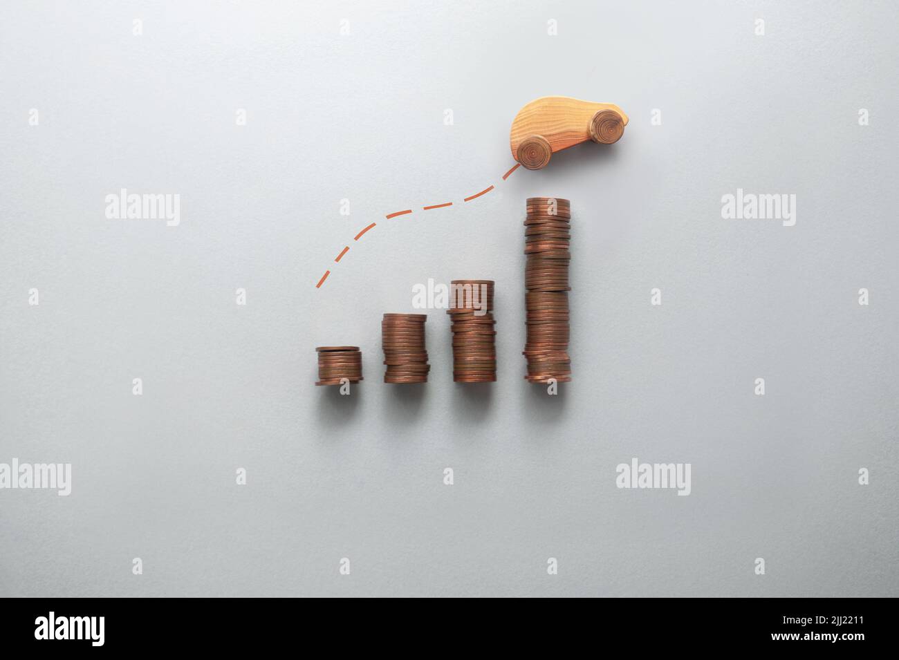 Increasing fuel, petrol, price concept, business chart stacks of coins with toy wooden car moving upwards Stock Photo