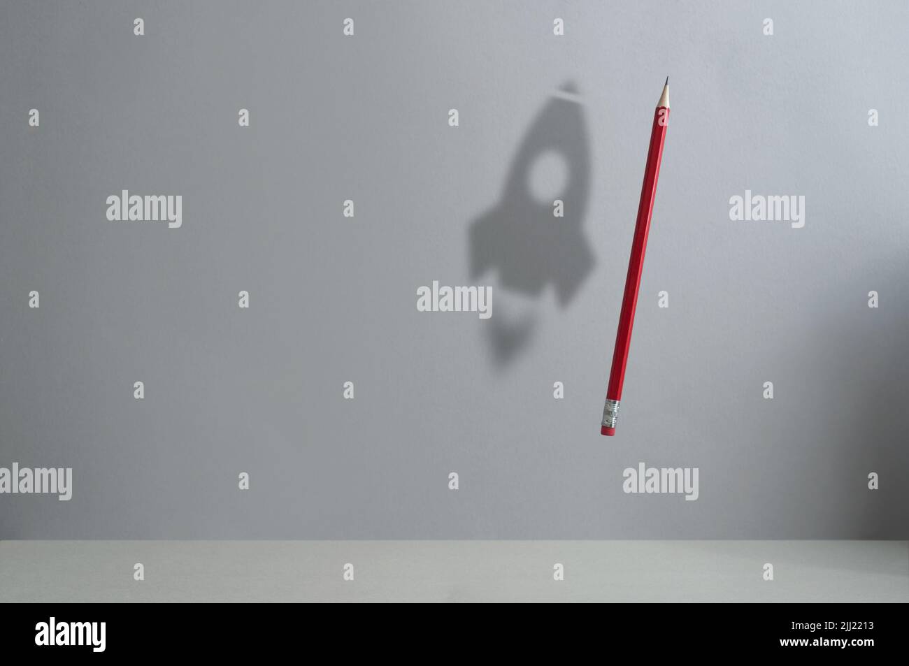 Pencil in air with shadow of a rocket, back to school, success concept Stock Photo