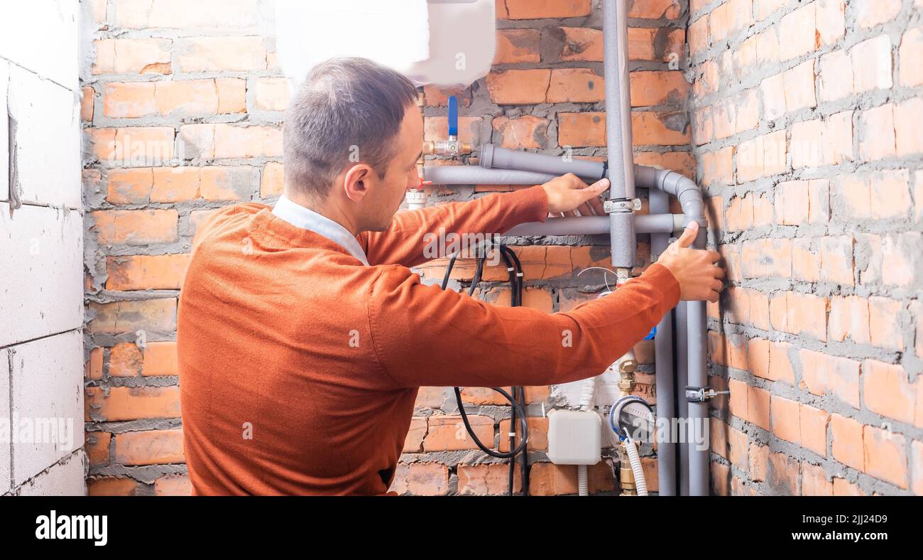 a plumber engineer repairing pipes at work Stock Photo - Alamy
